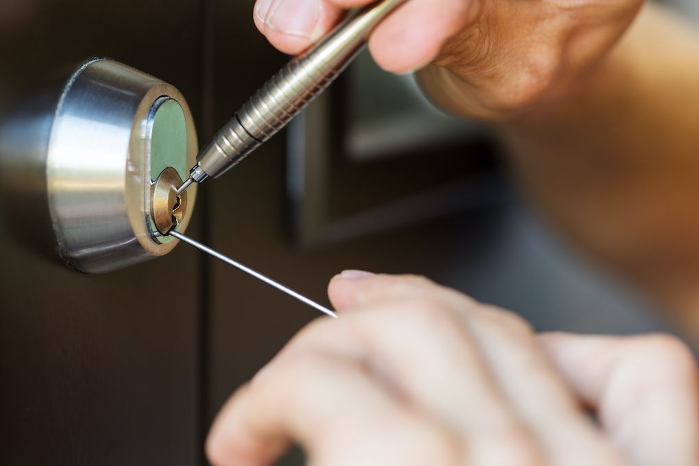 Locksmith picking a deadbolt lock